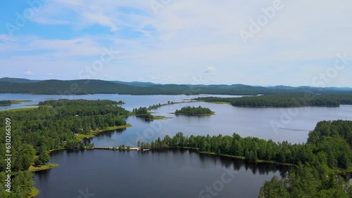 Panning drone shot of islands in an Adirondack lake surrounded by mountains photo