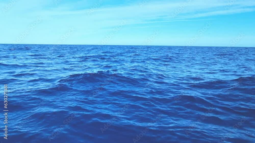 View of the waves of the sea or ocean and the blue sky View of the waves of the sea or ocean and the blue sky