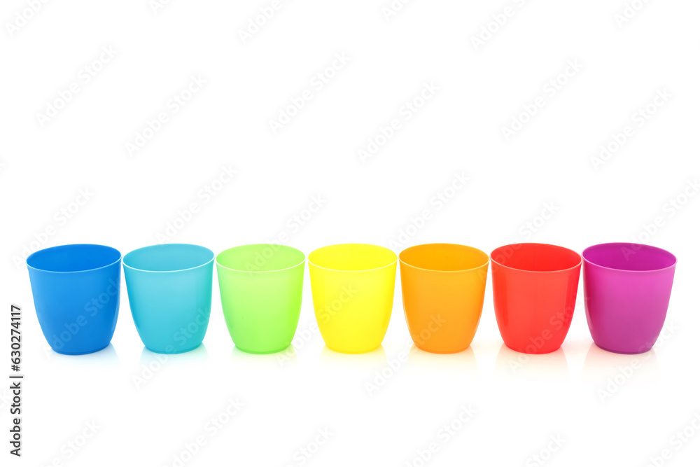 Rainbow drinking cups in a line on white background. Minimal colorful design composition with trans LGBT theme Rainbow drinking cups in a line on white background. Minimal colorful design composition with trans LGBT theme