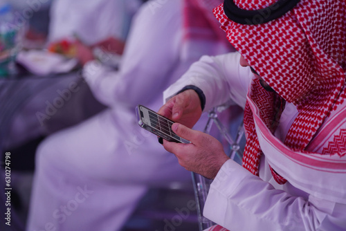 Saudi arab man Works on mobile phone reading or typing message