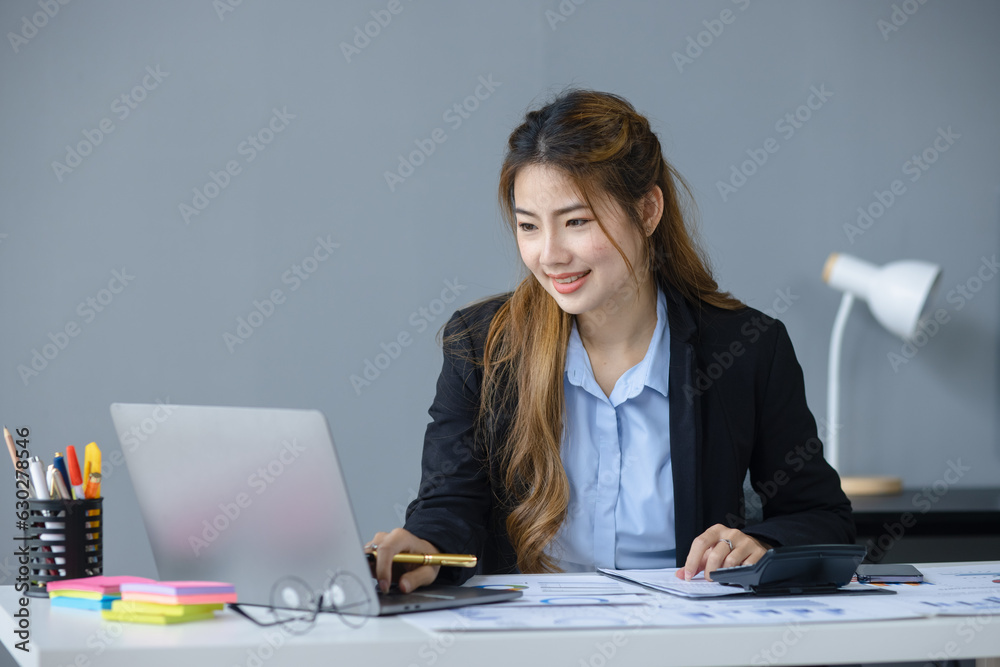 Asian businesswoman working with documents paper and laptop sitting at desk in office workplace, business finance and accounting, business online training concept. Asian businesswoman working with documents paper and laptop sitting at desk in office workplace, business finance and accounting, business online training concept.