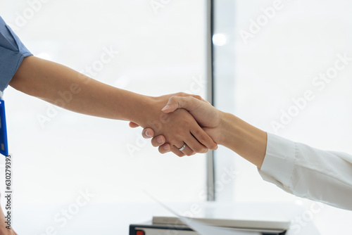 Closeup Handshake of employees after successful planning strategy marketing in the office