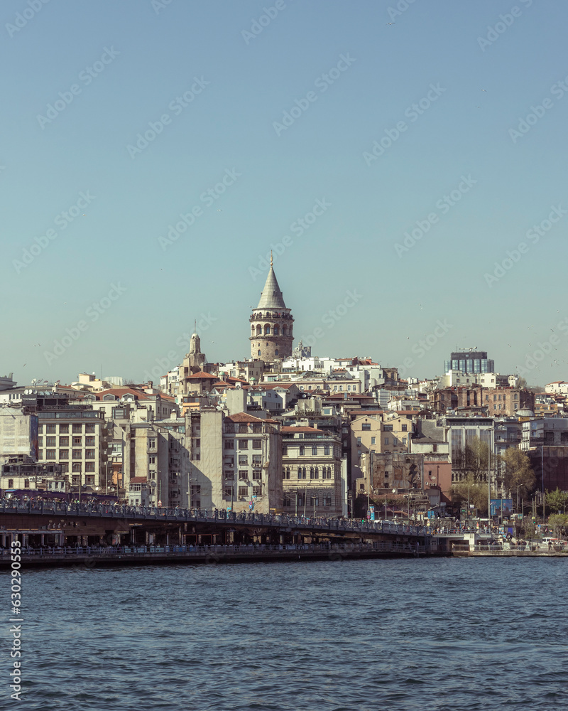 Istanbul, Turkey - 23 April 2023: View of the Galata Tower in Beyoglu district along the Golden Horn Strait, Istanbul downtown, Turkey. Istanbul, Turkey - 23 April 2023: View of the Galata Tower in Beyoglu district along the Golden Horn Strait, Istanbul downtown, Turkey.