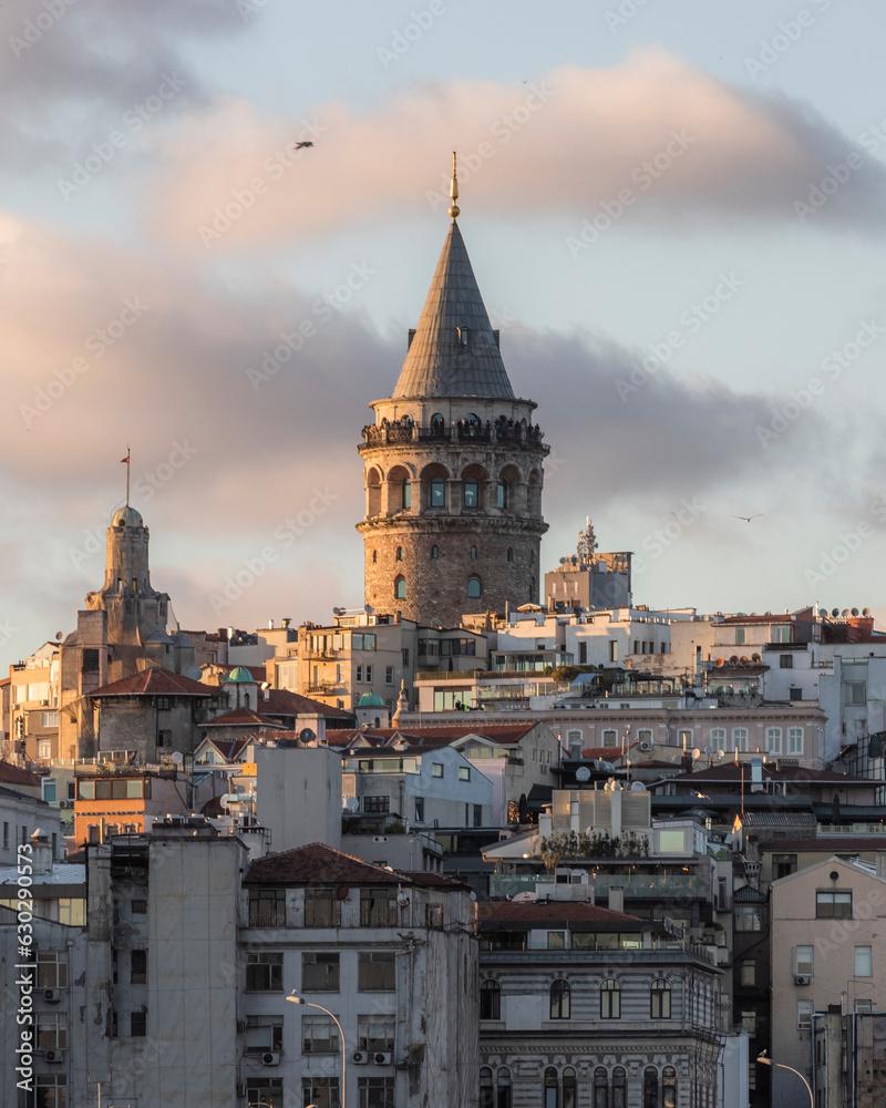 View of the Galata Tower in Beyoglu district at sunset along the Golden Horn Strait, Istanbul downtown, Turkey. View of the Galata Tower in Beyoglu district at sunset along the Golden Horn Strait, Istanbul downtown, Turkey.