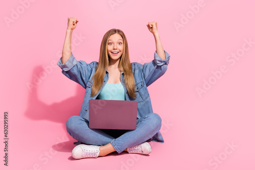 Photo of cheerful charming girl wear jeans outfit sit raise hands fist celebrate black friday discount isolated on pink color background © deagreez