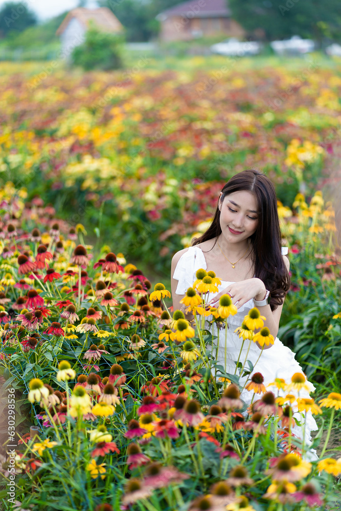 Beautiful Asian woman in a garden with beautiful colorful flowers Asian woman nature while relaxing in a flower garden, Chiang Mai, Thailand Beautiful Asian woman in a garden with beautiful colorful flowers Asian woman nature while relaxing in a flower garden, Chiang Mai, Thailand