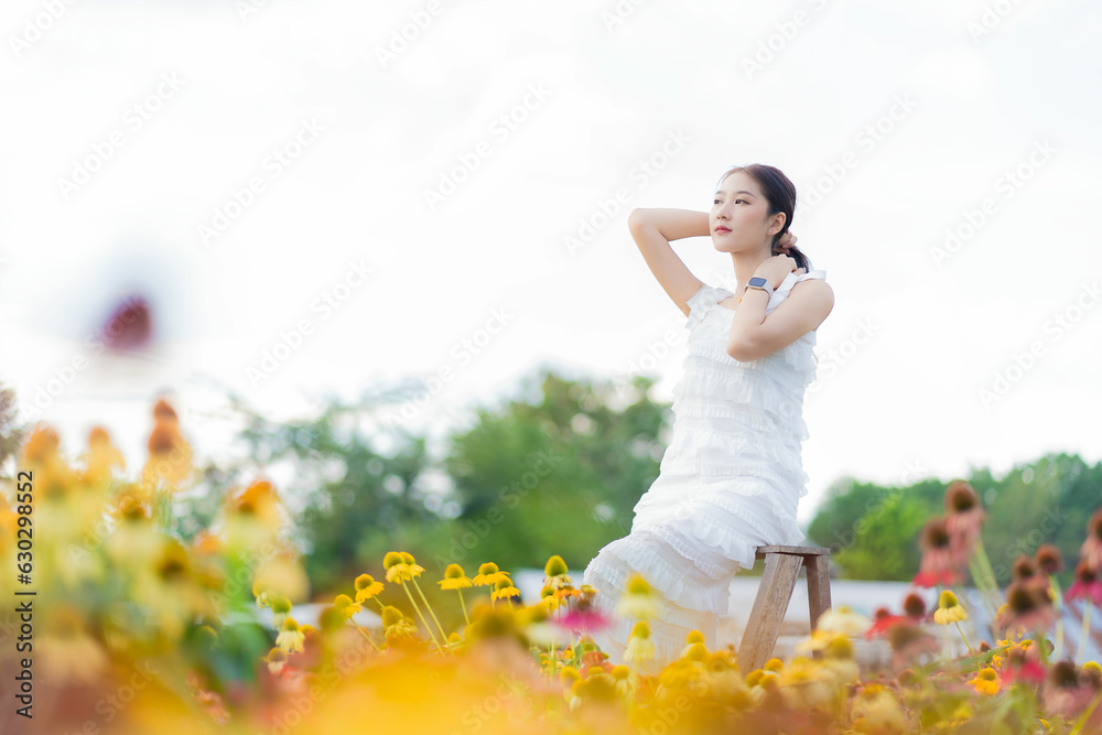 Beautiful Asian woman in a garden with beautiful colorful flowers Asian woman nature while relaxing in a flower garden, Chiang Mai, Thailand Beautiful Asian woman in a garden with beautiful colorful flowers Asian woman nature while relaxing in a flower garden, Chiang Mai, Thailand