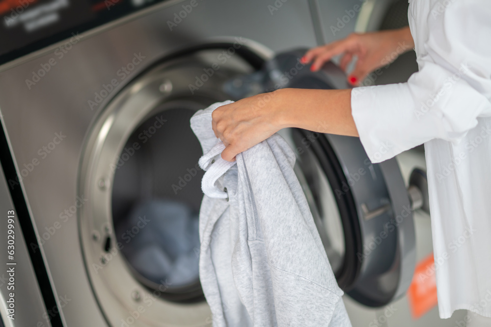 Unrecognizable woman doing laundry. Unrecognizable woman doing laundry.