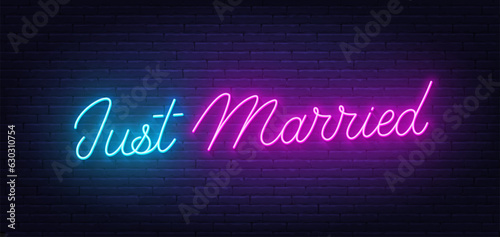 Just Married neon lettering on brick wall background.