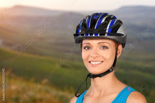 Cyclist woman in a helmet at mountain background