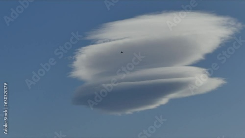 Blue sky with moving Lenticular clouds, Lenticularis lentil-shaped during Foehn wind - timelpase. Topics: weather phenomenon, weather, toposphere, meteorology