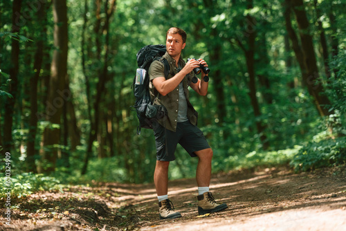 Tourist in summer forest. Conception of exploration and leisure © standret