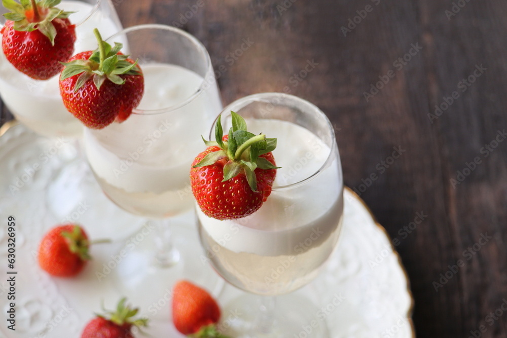 Glass of strawberry cocktail or mocktail, refreshing summer drink with champagne, strawberries, ice cream Glass of strawberry cocktail or mocktail, refreshing summer drink with champagne, strawberries, ice cream