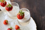 Glass of strawberry cocktail or mocktail, refreshing summer drink with champagne, strawberries, ice cream