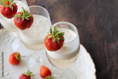 Glass of strawberry cocktail or mocktail, refreshing summer drink with champagne, strawberries, ice cream