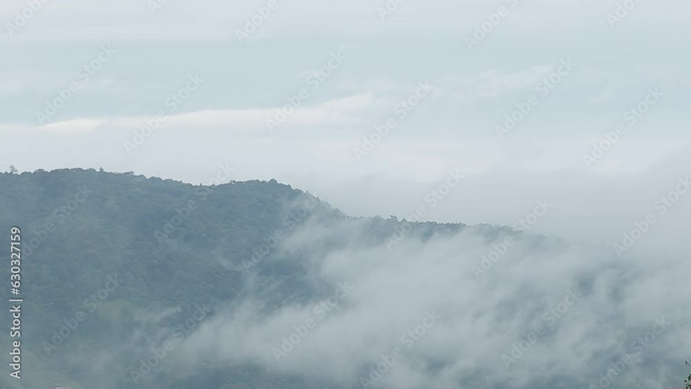 Mountain range with visible silhouettes through the morning blue fog. Mountain range with visible silhouettes through the morning blue fog.