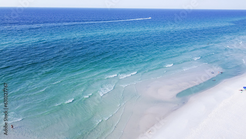 Aerial view brilliantly white sandy shore with crystal-clear turquoise water and gorgeous shade of blue waves along miles of untouched beaches Santa Rosa, Walton County, Florida, USA photo