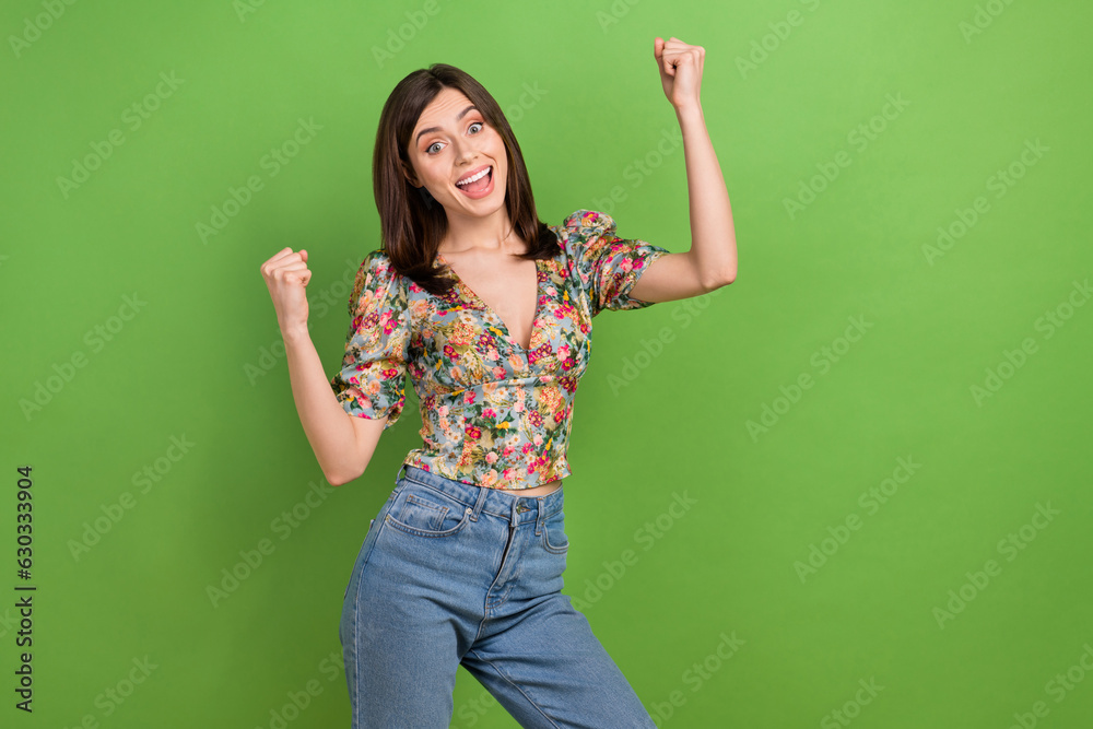 Photo of young awesome champion girl fists up wear stylish spring trendy blouse hooray weekend chill isolated on green color background Photo of young awesome champion girl fists up wear stylish spring trendy blouse hooray weekend chill isolated on green color background