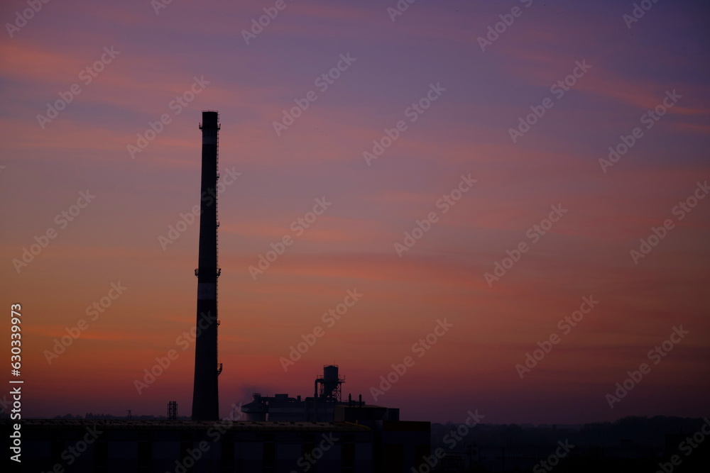 Industrial pipe on the background of beautiful sunset. Evening time
