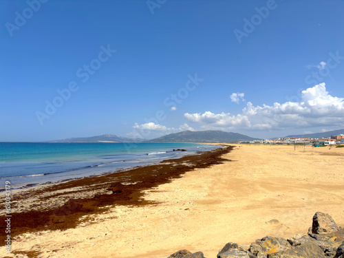 Fototapeta Naklejka Na Ścianę i Meble -  extensive wide sandy beach and dunes in Tarifa at a beautiful summer day and blue sky, Llaya de los Lances, Playa Santa Catalina, Andalusia, province of Cádiz, Spain