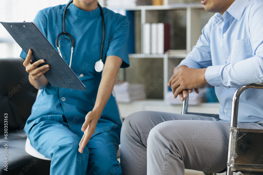 Female doctor is giving physical therapy advice to a male patient in a wheelchair. Female doctor is giving physical therapy advice to a male patient in a wheelchair.