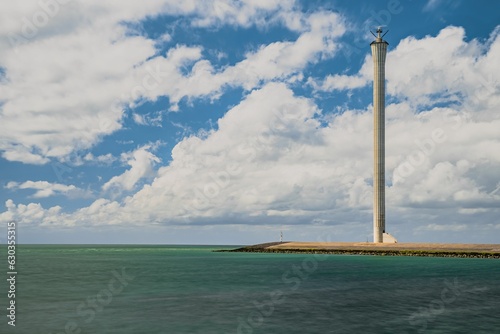 A majestic lighthouse atop a rocky outcropping on the seashore, Neeltje Jans, Iceland photo