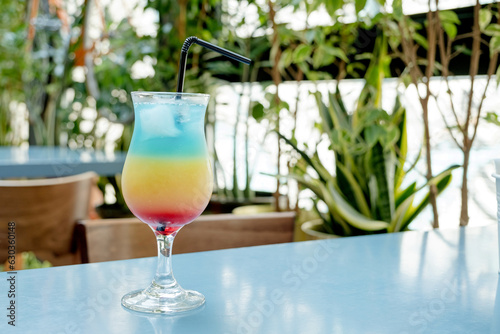 three layer refreshing tropical cocktail in real cafe