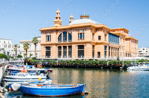 Bari, Italy, July 30, 2023. Margherita Theatre with colorful fishing boats.