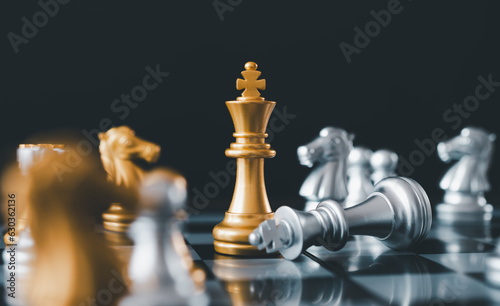 stand of golden king chess and fallen silver king chess.chess board game concept of business ideas and competition and stratagy plan success meaning