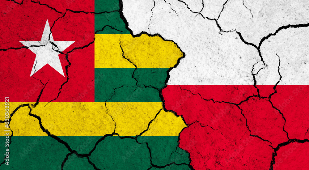 Flags of Togo and Poland on cracked surface - politics, relationship concept