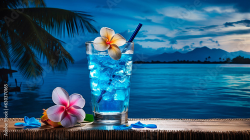Summer holiday concept. Blue hawaii soda cocktail on blur tropical beach and blue sky background.
