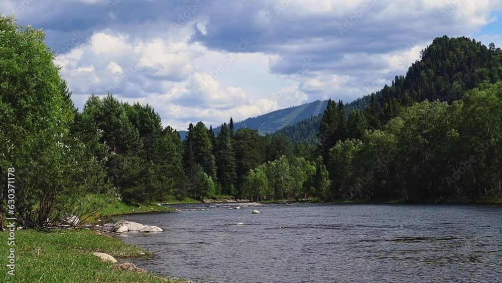 Mountain river in the wild. A clear stream of water flowing through stone boulders. A beautiful view of the picturesque river and mountains. Slow motion video. High quality Full HD footage Mountain river in the wild. A clear stream of water flowing through stone boulders. A beautiful view of the picturesque river and mountains. Slow motion video. High quality Full HD footage