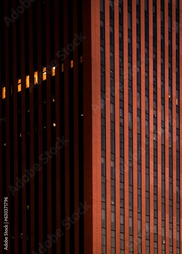 an outside photo of a building at night time with one large light shining