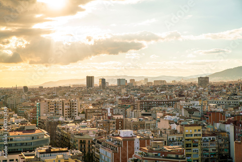 Elevated view of the cityscape and rooftops in Barcelona with towers in the background, Spain