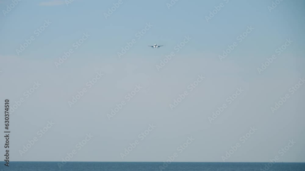 Airplane approaching for landing. Long shot of an airliner descending. Plane flies over sea. Tourism and travel concept Airplane approaching for landing. Long shot of an airliner descending. Plane flies over sea. Tourism and travel concept