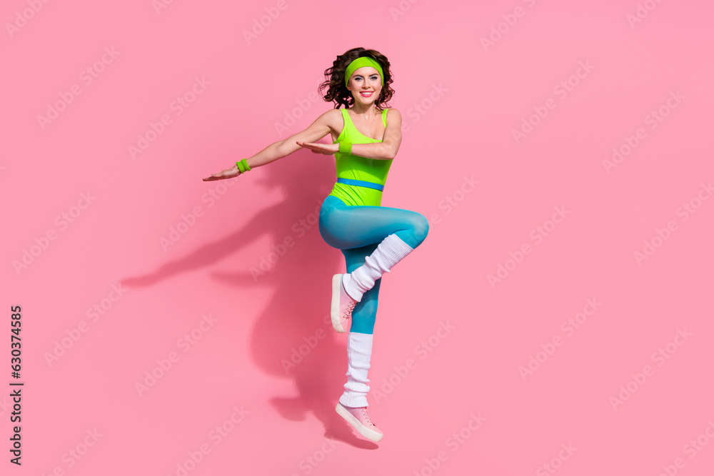 Photo of funny positive lady sportive coach jump dancing stretching exercise isolated pastel color background Photo of funny positive lady sportive coach jump dancing stretching exercise isolated pastel color background