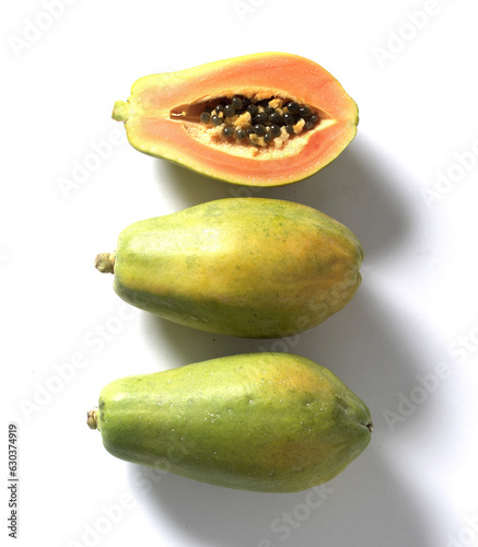 Fresh  whole papaya and sliced papaya lay in row isolated on white background