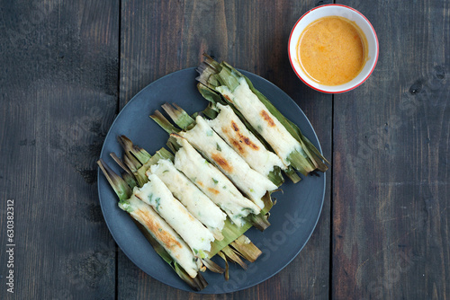 Otak-Otak is an Indonesian snack. The main ingredient of the dish is ground fish paste. Otak-otak is traditionally served steamed or grilled, encased within the leaf parcel it is cooked in.            photo
