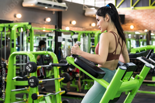 Sexy sportswoman doing exercise in fitness gym sport club