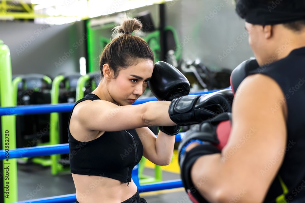 Sexy Asian sport fitness woman doing exercise with machines in gym club Sexy Asian sport fitness woman doing exercise with machines in gym club