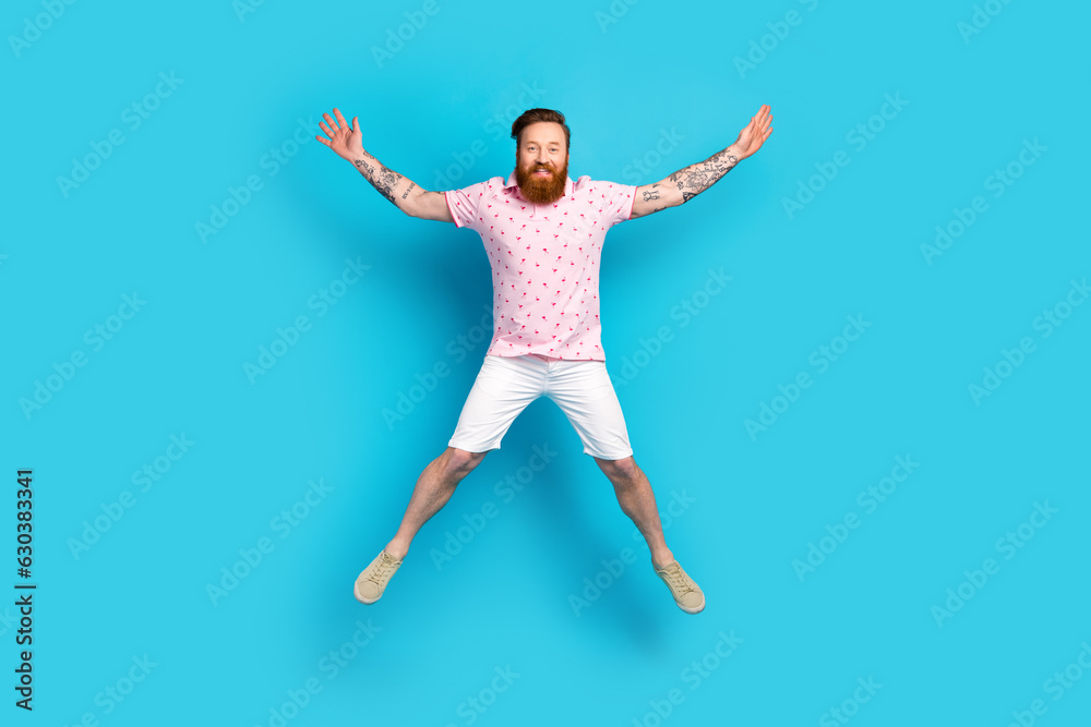 Obraz premium Full size portrait of overjoyed nice person jumping raise hands make star figure isolated on blue color background