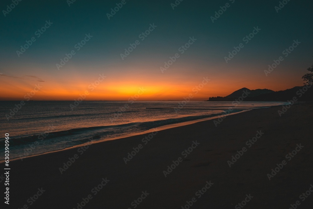 Beautiful sunset view of the ocean and mountain landscape