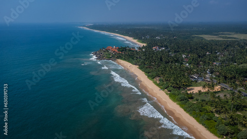 Coast of Sri Lanka. Indian Ocean, beach and hotels among the jungle and palm trees