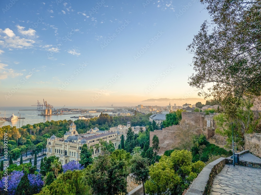 Aerial view of Malaga, Spain, with a vibrant cityscape at sunset