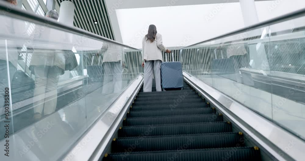 Airport, luggage and back view of business people on an escalator for international travel or transport. Corporate, global and professional workers in a terminal with suitcase for a trip or journey Airport, luggage and back view of business people on an escalator for international travel or transport. Corporate, global and professional workers in a terminal with suitcase for a trip or journey