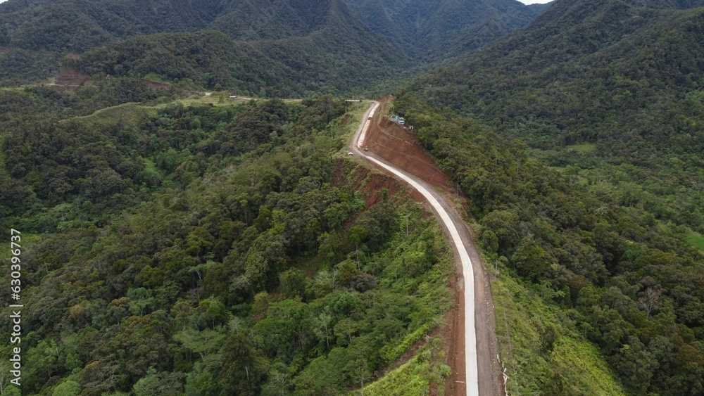 Aerial rural road winding through a mountainous landscape