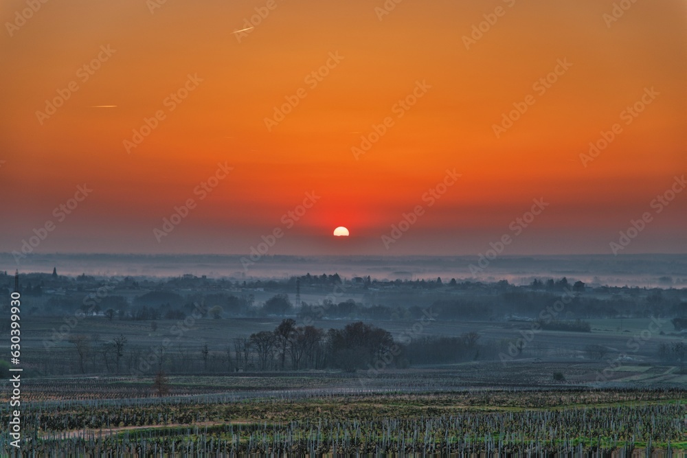 Sunset over the rural field in the mist