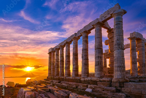 Sunset sky and ancient ruins of temple of Poseidon, Sounion, Greece