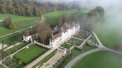 Aerial of the Waldegg Castle in Feldbrunnen-St. Niklaus, Switzerland on a foggy day photo