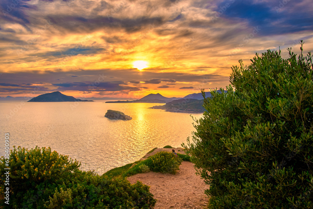 Sunset over Greek islands at Mediterranean sea, bay of Sounio, Greece.